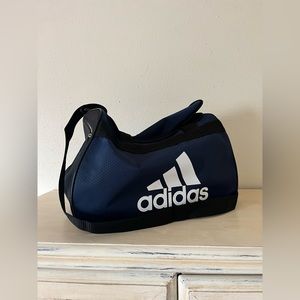 Medium sized navy blue Adidas gym bag with ample storage and easy to carry!